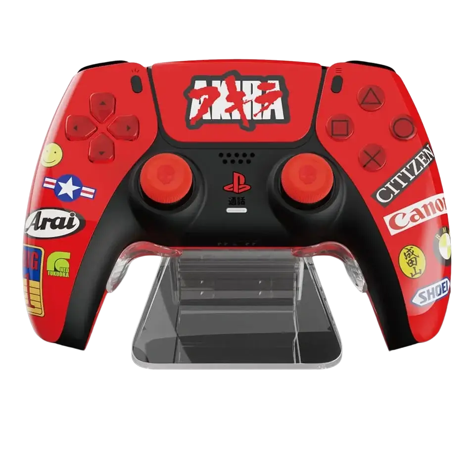 Red and black playstation 5 dualsense controller with akira and brand stickers on phantom stand controller holder rack
