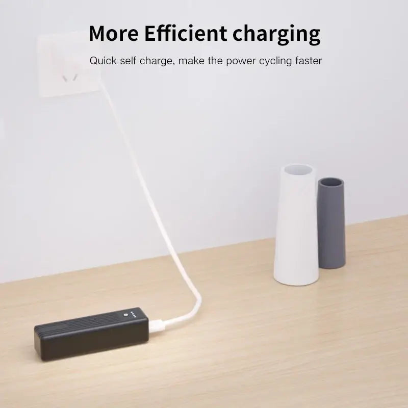 Phomax 5000mah black portable power bank with type-c input and white charging cable plugged in for mobile use