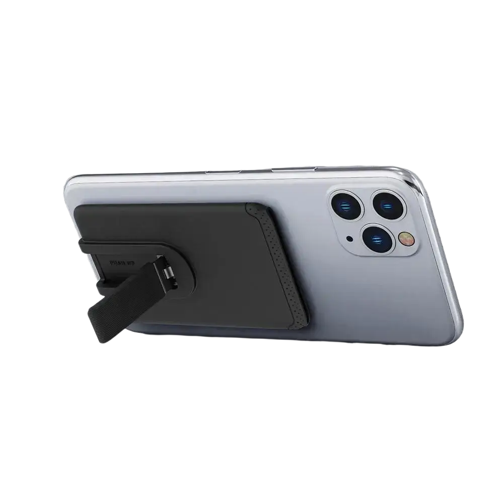 Black magnetic phone card holder silicone stick-on wallet with textured grip and usb port on back of silver mobile phone