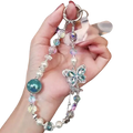 Delicate silver butterfly mobile phone chain with iridescent beads and a sparkling teal glass sphere centerpiece