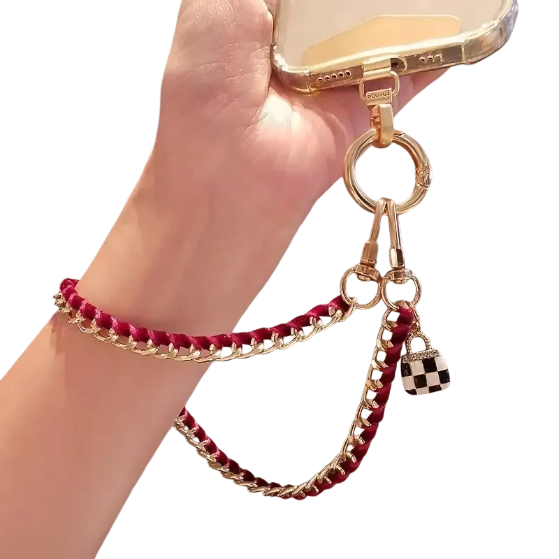 Gold-toned chain phone wrist strap with burgundy braided cord and black and white checkered lock charm anti lost hand lanyard