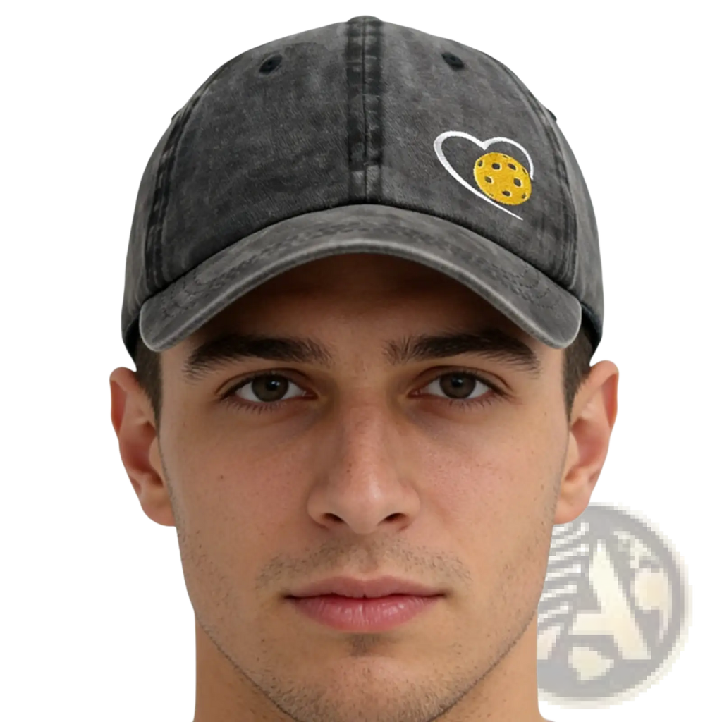 A dark gray distressed cotton baseball cap with a white embroidered heart and yellow pickleball inside