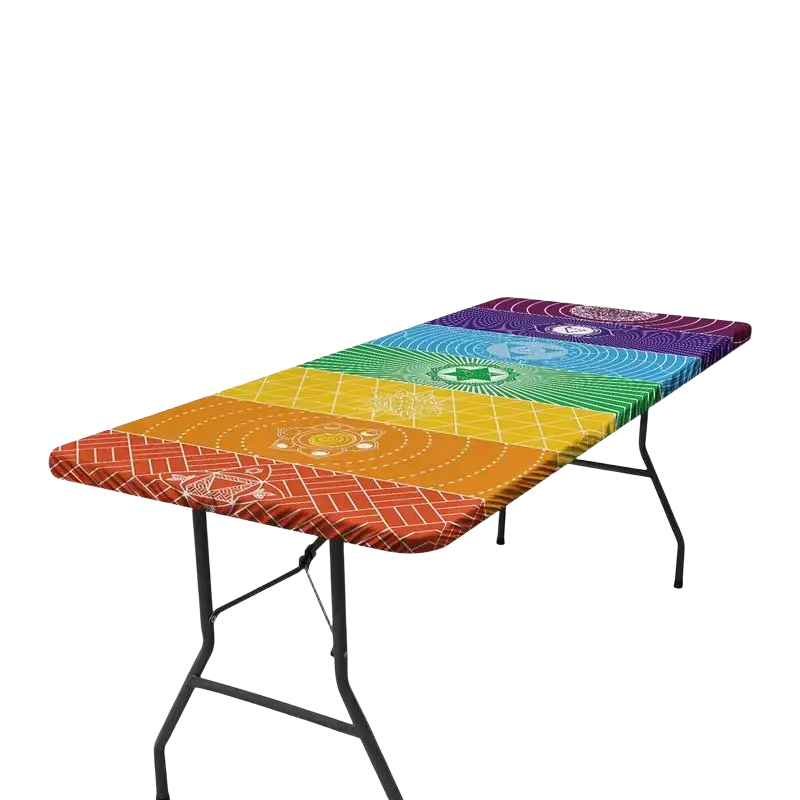 Vibrant rainbow polyester picnic table cover with intricate chakra designs fitted on a foldable black metal picnic table