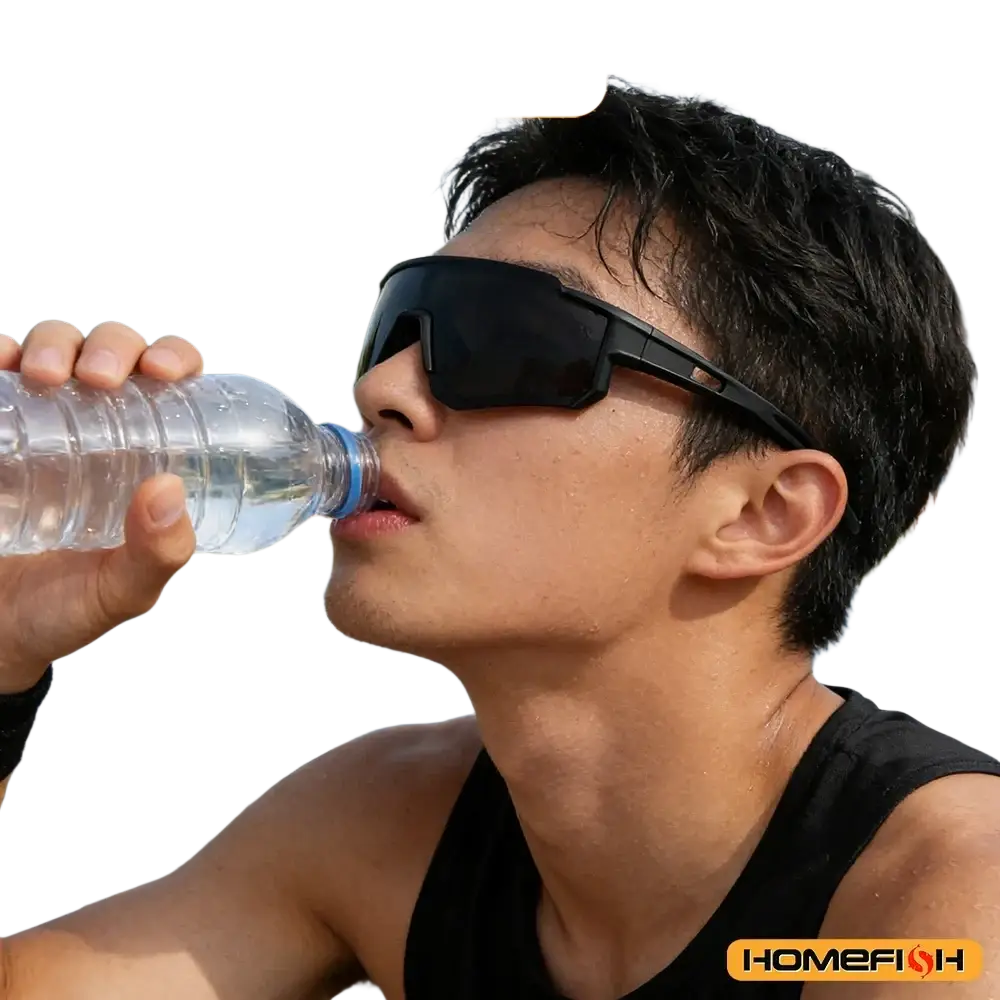 A man wearing black framed one-piece bicycle windscreen sport sunglasses with dark lenses drinks from a water bottle