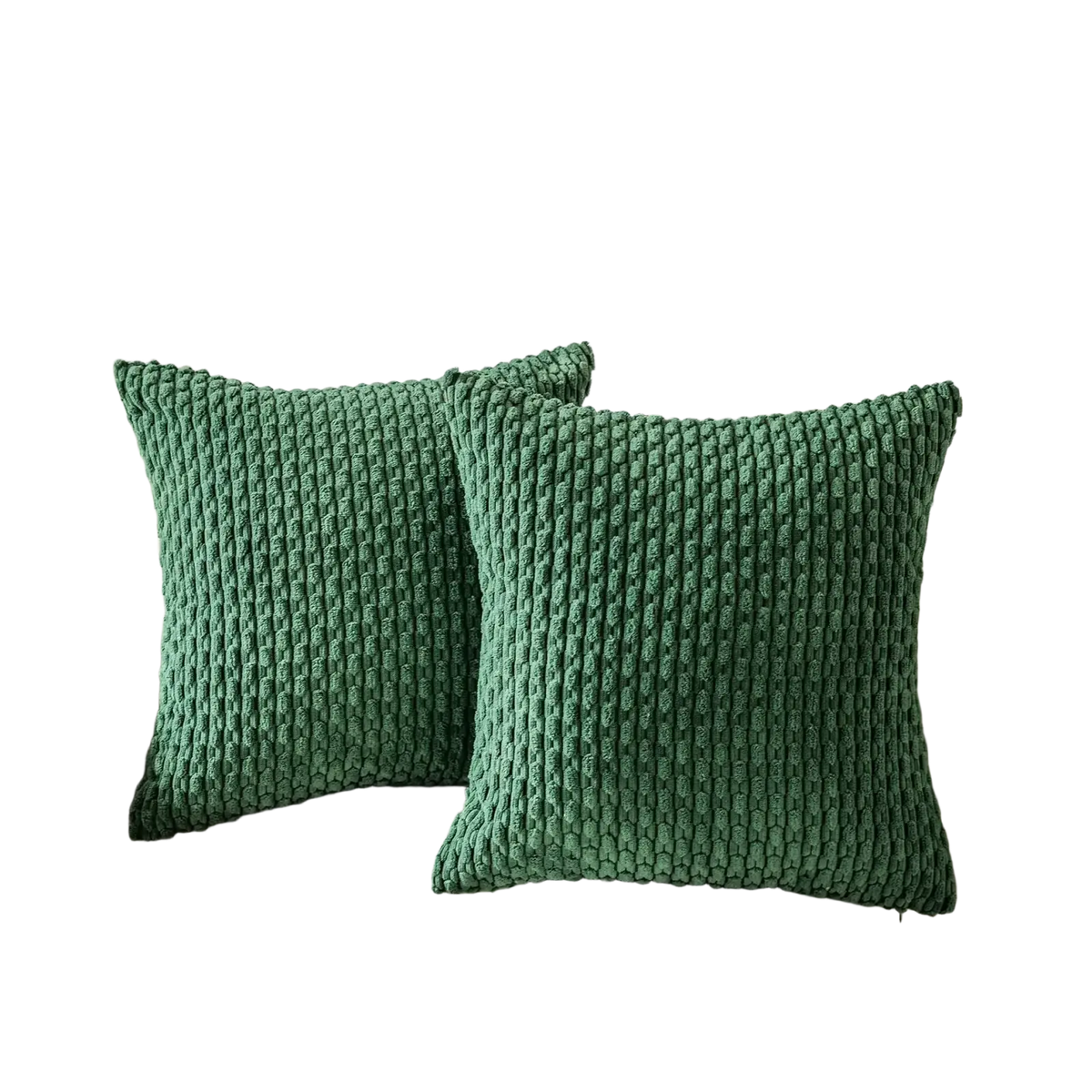 Two emerald green chunky-knit pillow covers with ribbed texture on a cream sofa for stylish home decor