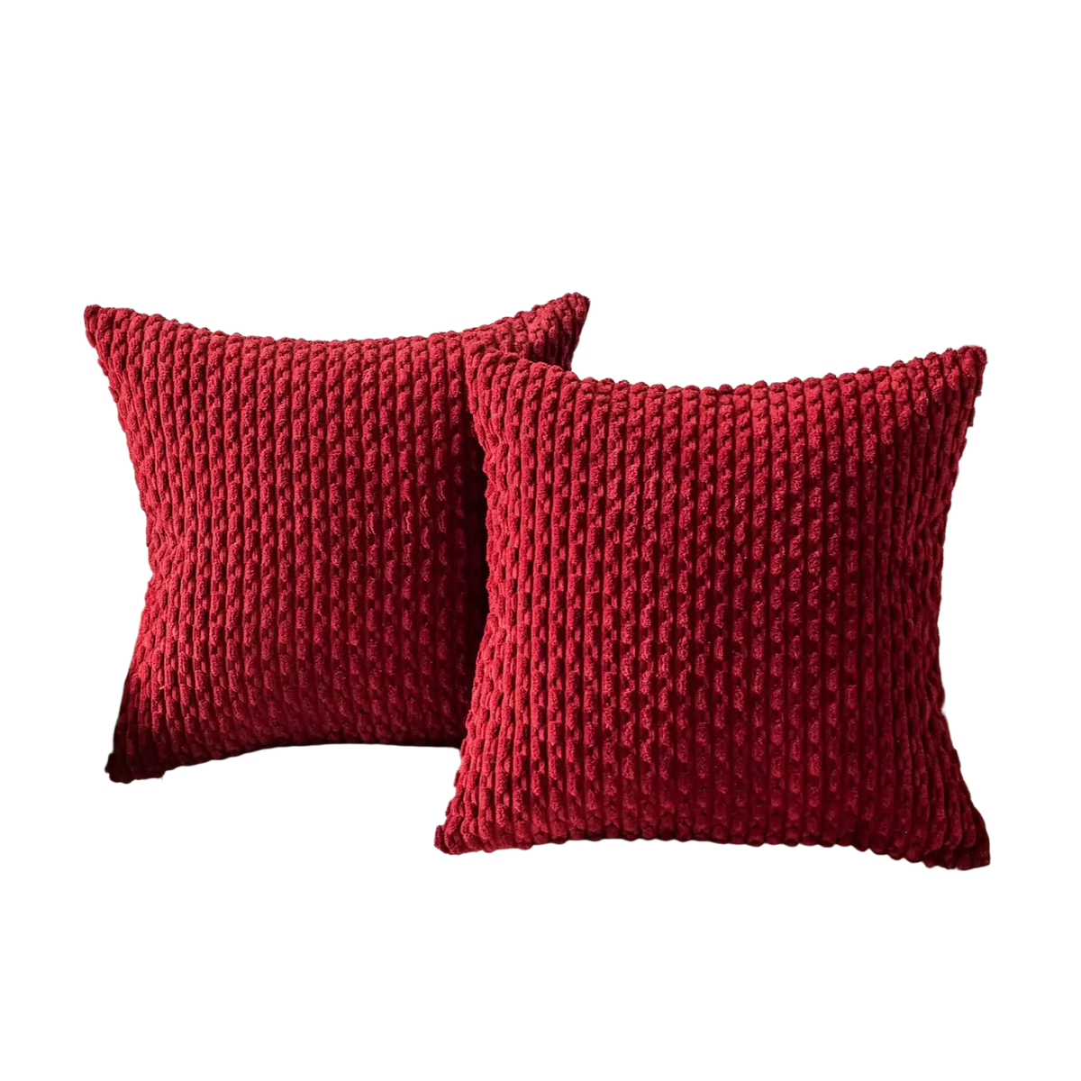 Two vibrant red chunky-knit pillow covers with ribbed texture on a white sofa for stylish home decor use