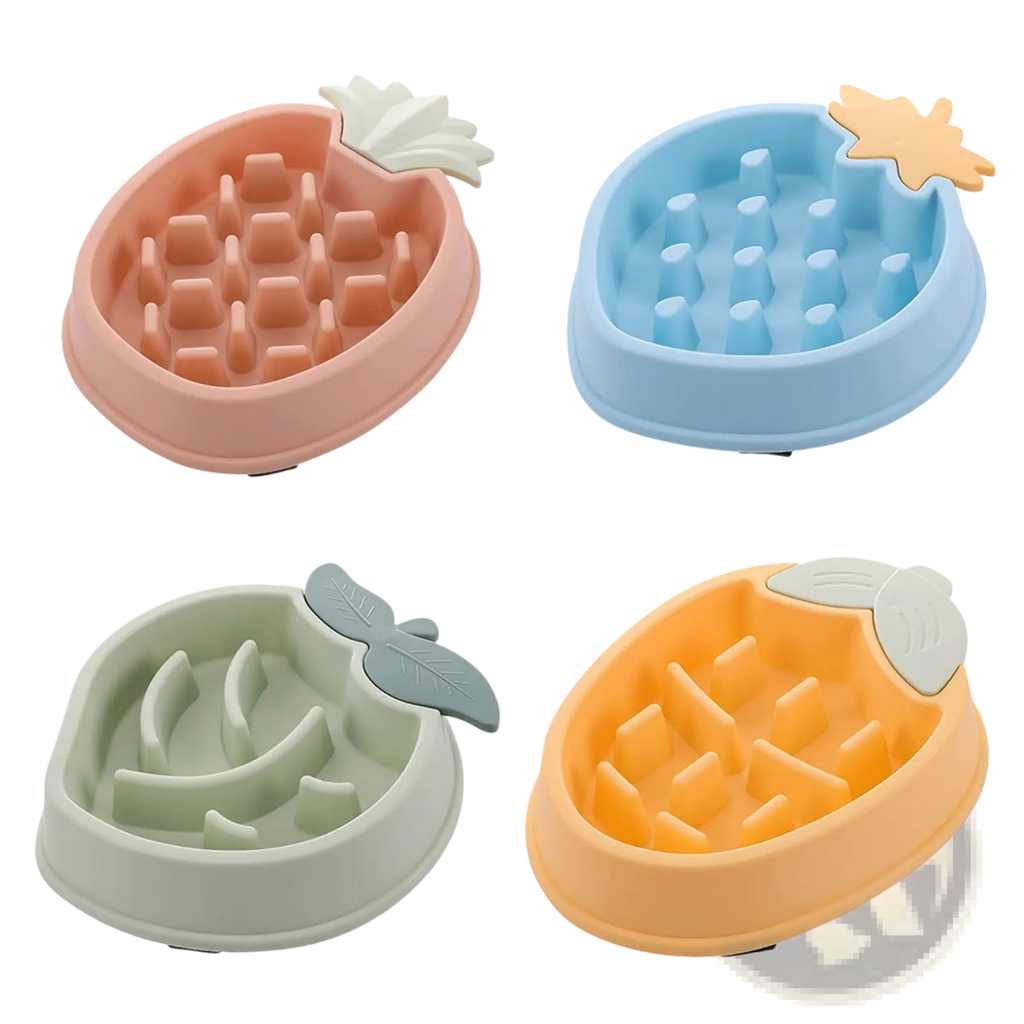 Four colorful pastel pineapple slow feeder dog bowls in plastic with molded leaf tops for pet feeding