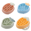 Four colorful pastel pineapple slow feeder dog bowls in plastic with molded leaf tops for pet feeding