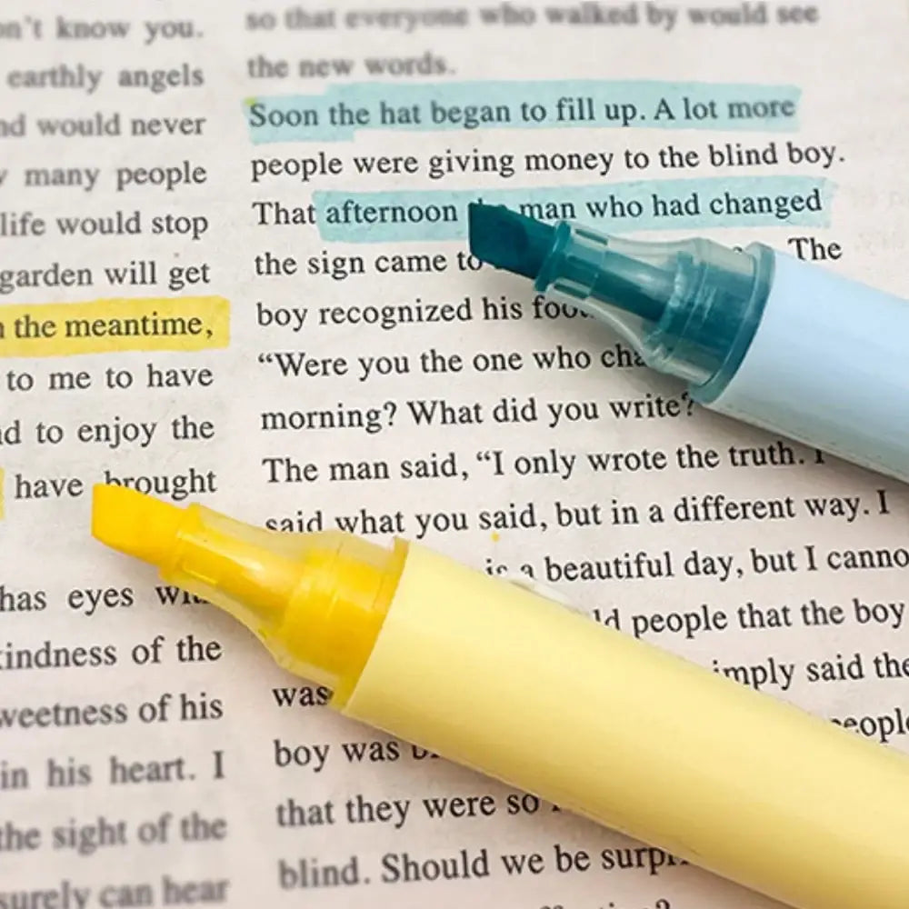 A yellow and teal highlighter pen resting on a page with highlighted text from the pink 11 piece student stationery set