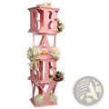 Pink baby shower balloon box party decoration featuring a pink baby letter display stand with white and pink flowers