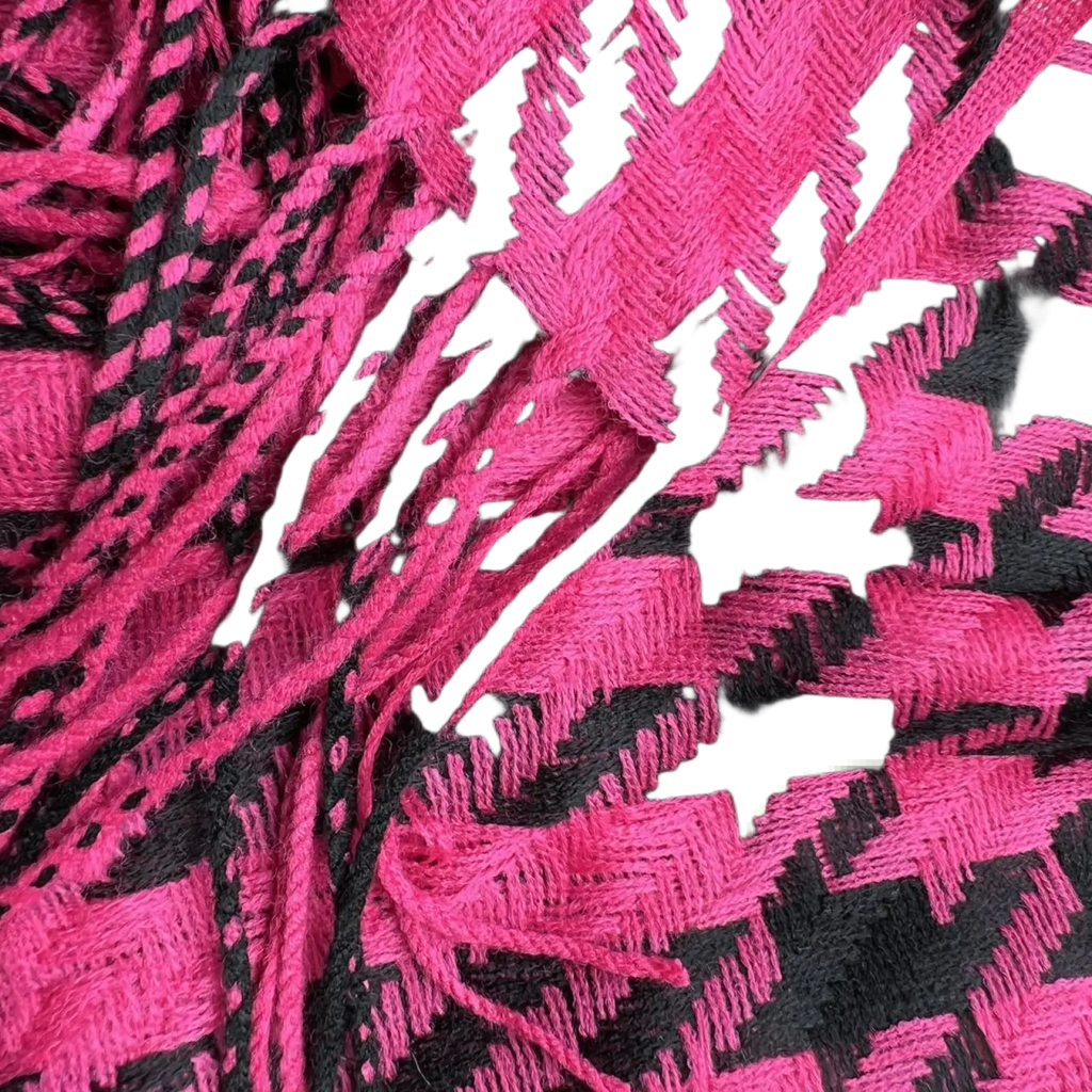 A vibrant pink and black jacquard winter scarf featuring a bold houndstooth geometric pattern woven in soft fabric