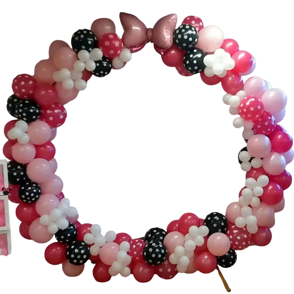 Pink bow balloon arch kit featuring a festive pink black and white balloon arch with polka dots and floral clusters