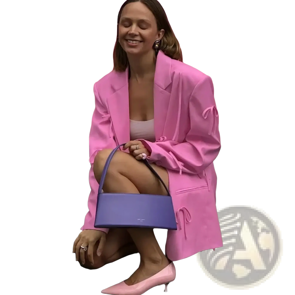 Purple structured handbag with single shoulder strap complementing pink bow y2k blazer jacket in fashion ensemble