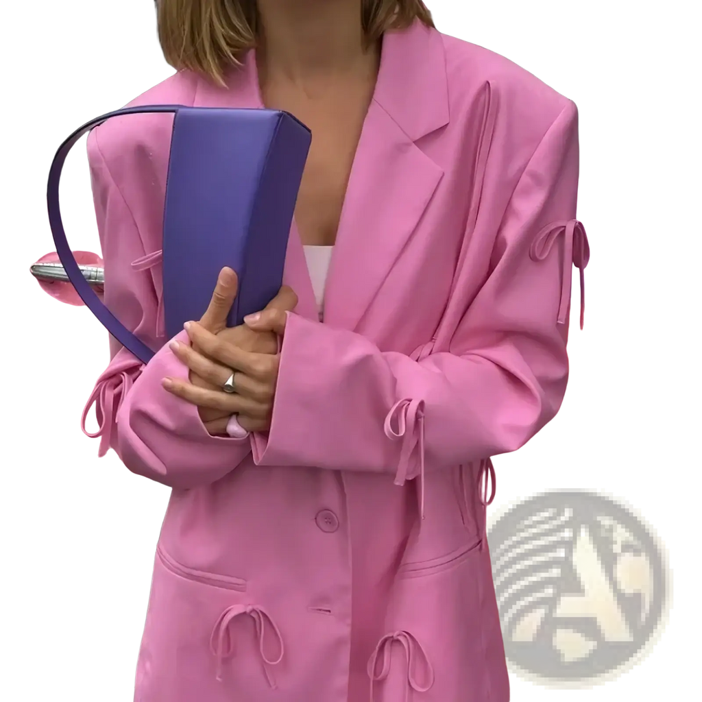 A sleek two-tone handbag with vibrant purple body and matching curved handle complementing a pink bow Y2k blazer jacket