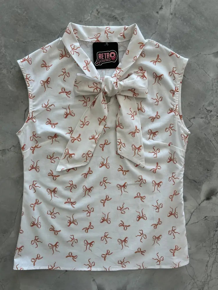 White sleeveless cotton blouse with red bow print and matching neckline bow by retro lifestyles brand
