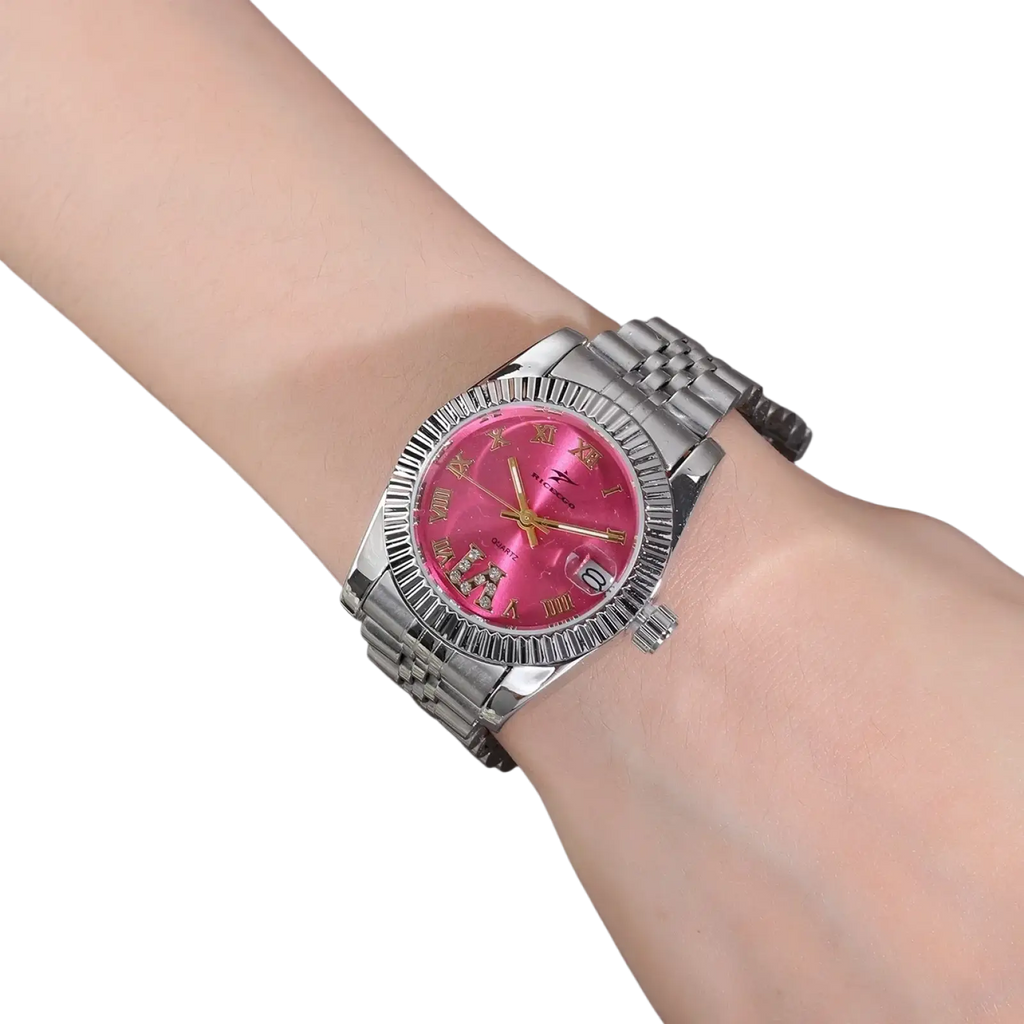 A sleek silver-toned stainless steel luxury quartz watch with a vibrant pink dial and gold-tone hands