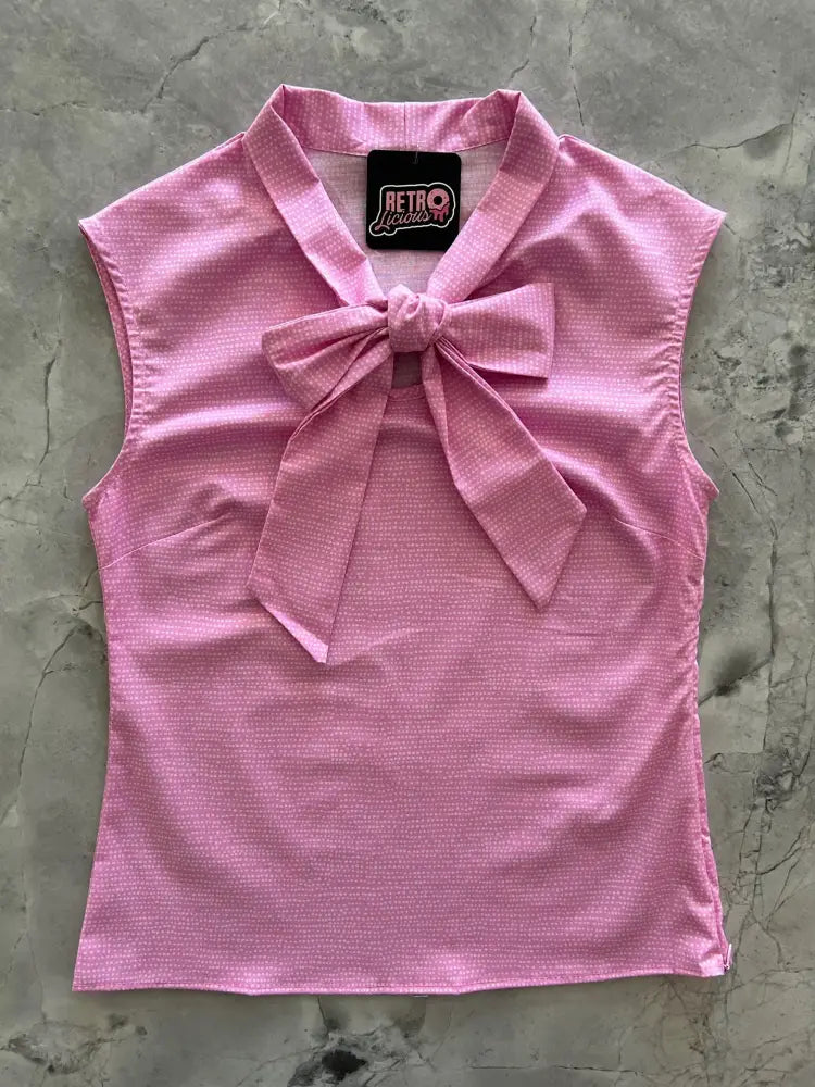 Vintage pink sleeveless cotton top with textured fabric and prominent bow at neckline for elegant wear