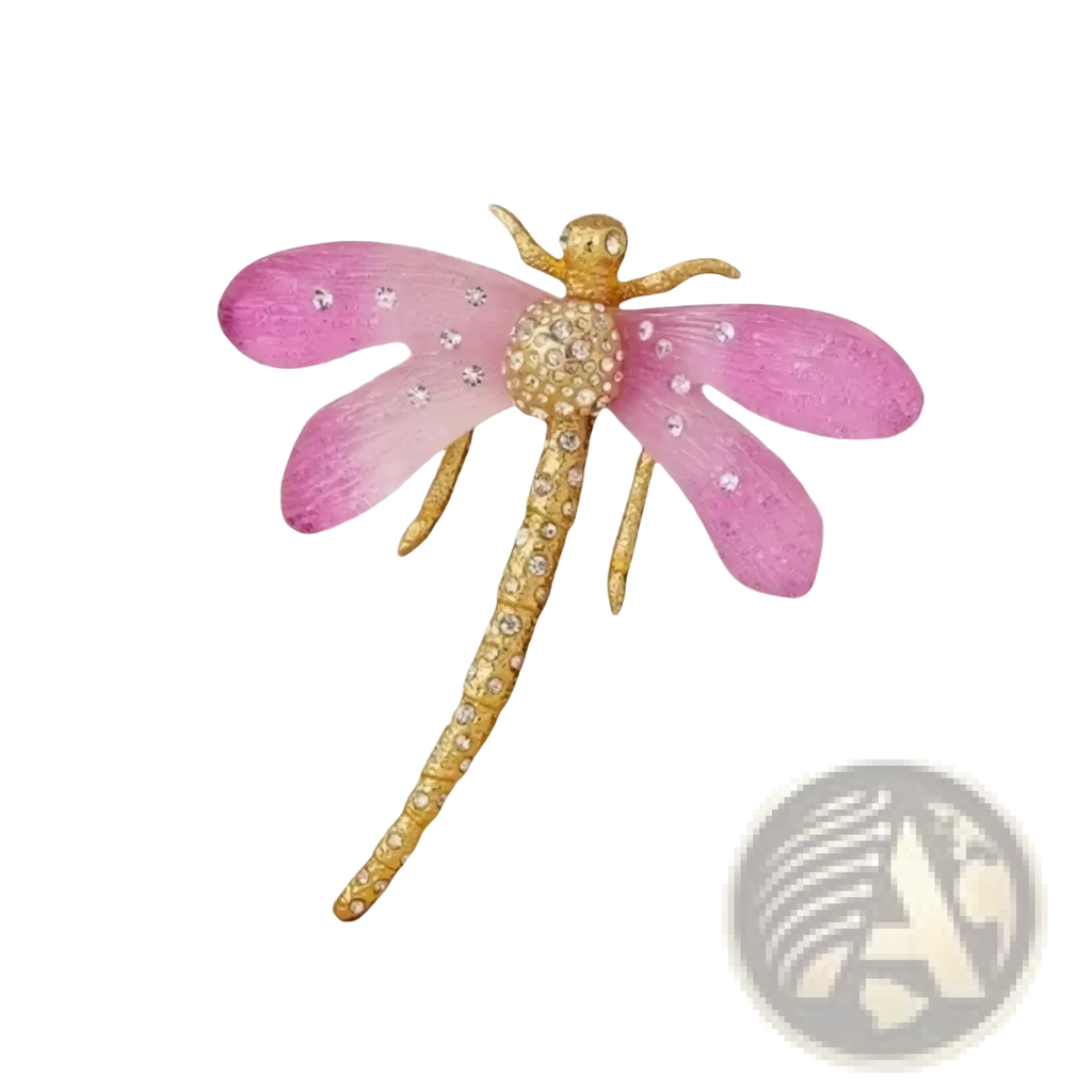 A delicate pink dragonfly crystal brooch pin with gold-toned wings and body adorned with sparkling diamonds