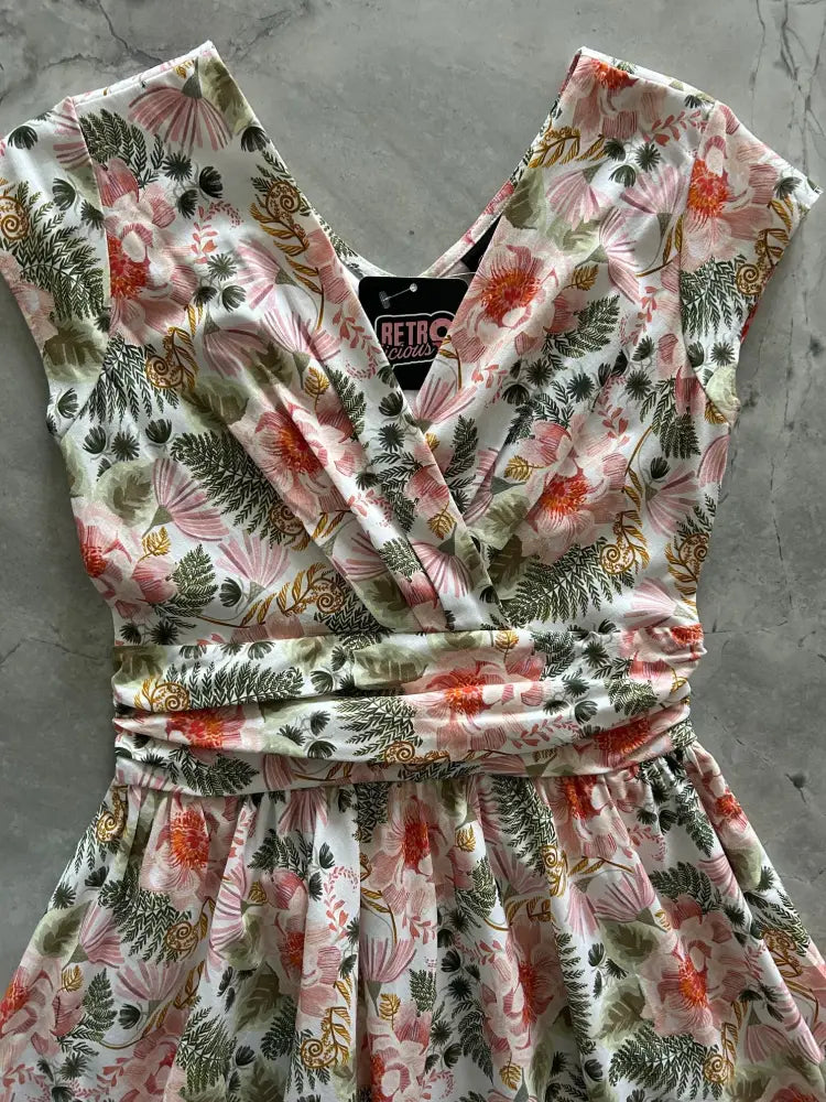 Pink floral Greta vintage cotton knee length dress with wrap-around neckline and matching belt on cream background