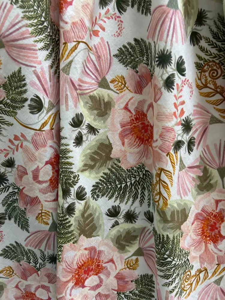 Pink floral greta vintage cotton knee length dress with soft flowing fabric and delicate pink blossoms on light background