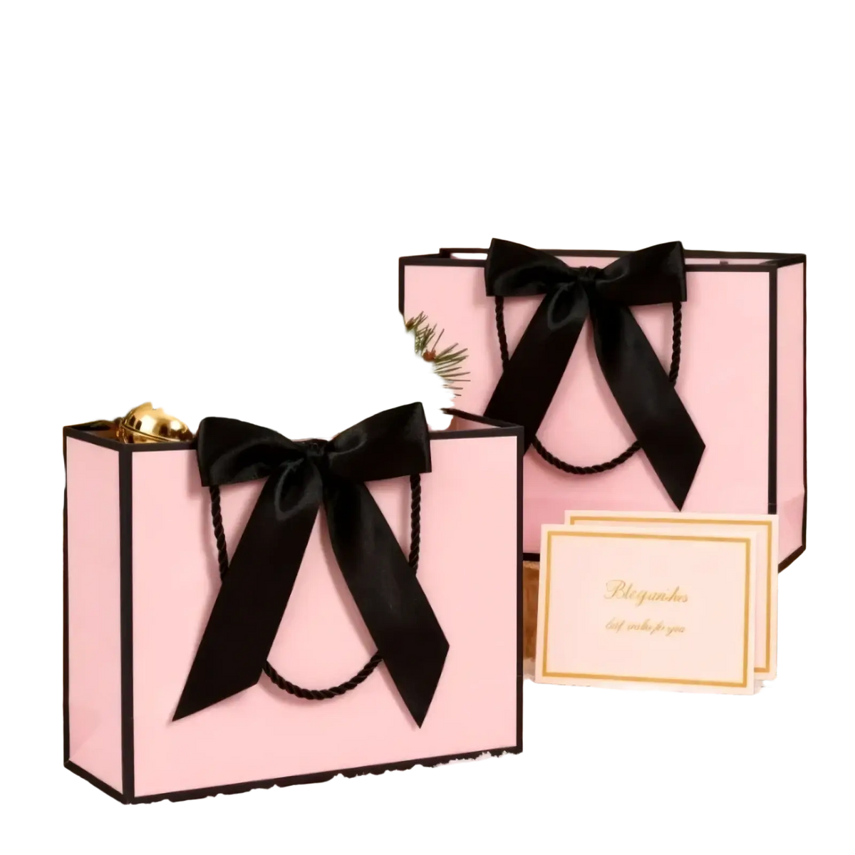 Pink gift bags with black satin bows gold bells and pine branches in a bows and cards set for festive packaging