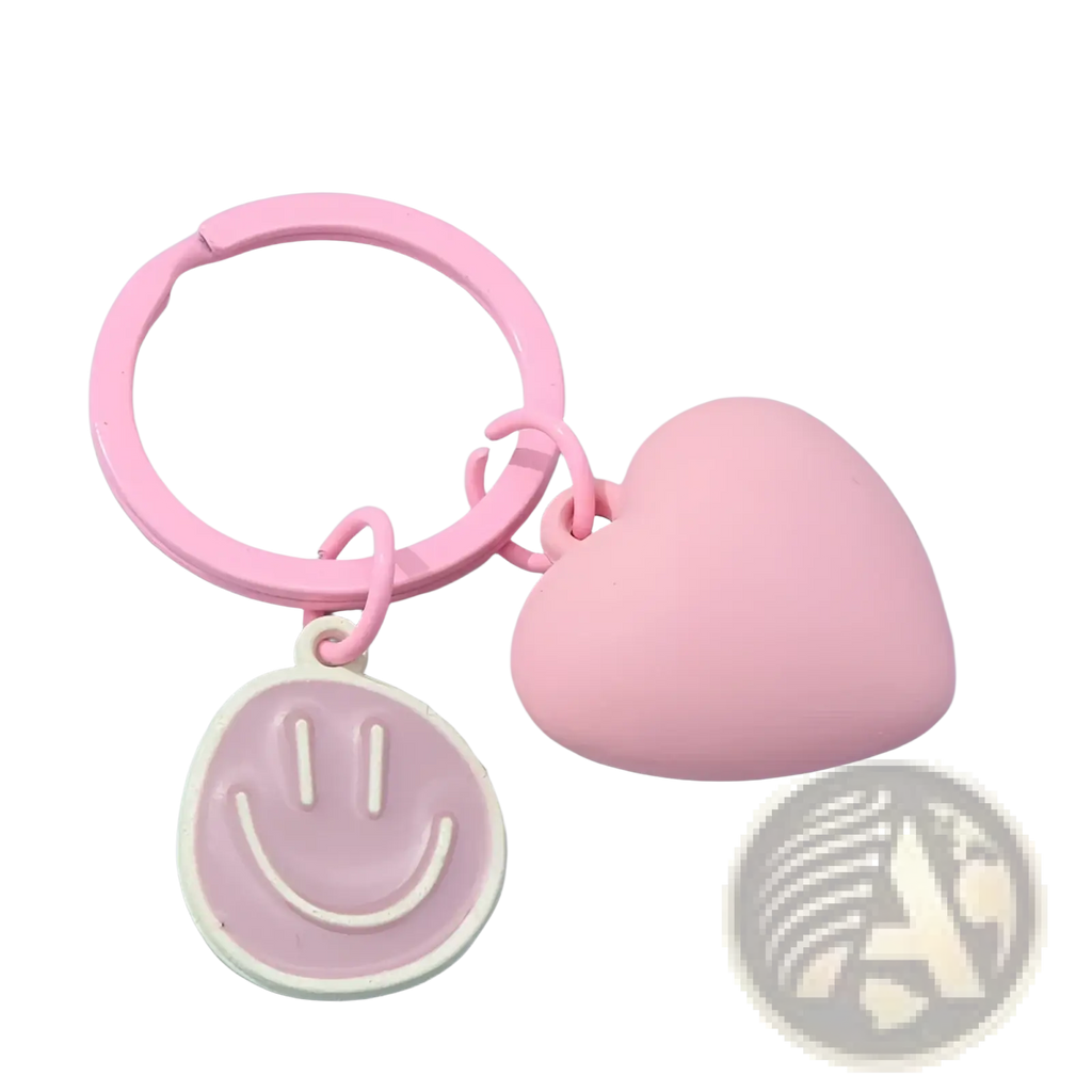 Pink plastic keychain with a heart-shaped charm and smiley face pendant for decorative use