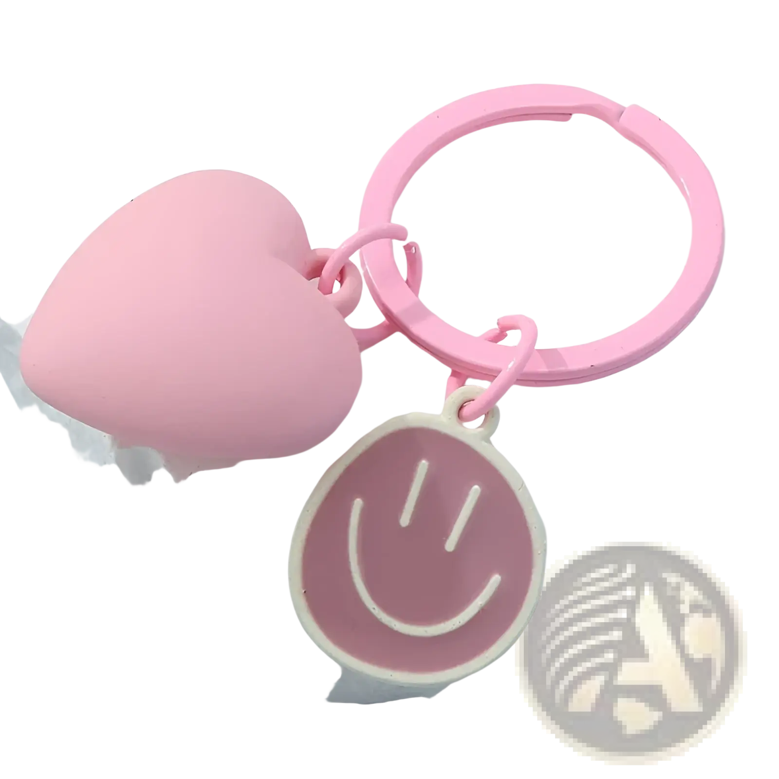 Pink heart smiley face keychain featuring a pink heart-shaped keychain with a smiling face charm attached