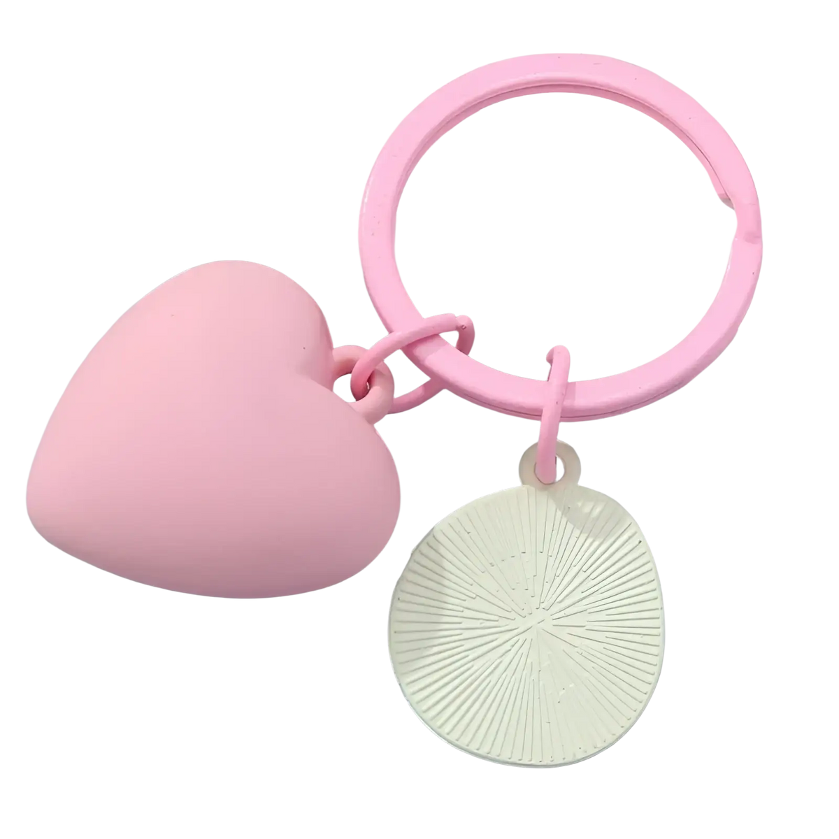 Pink heart smiley face keychain featuring a pink heart ring and an off-white circular charm with radial grooves
