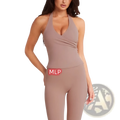 A taupe form-fitting halter top with deep v-neckline and ruching detail paired with pink high-waisted fitness leggings