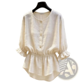 Cream-colored linen blouse with puff sleeves and ruffled cuffs highlighting elegant feminine style