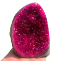 Pink quartz geode crystal cluster home decor featuring a vibrant fuchsia crystalline interior and smooth translucent shell