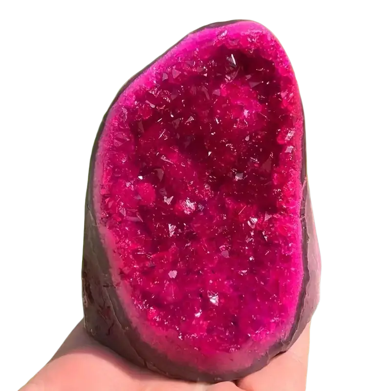 Pink quartz geode crystal cluster with vibrant fuchsia crystalline interior and dark earthy exterior for home decor