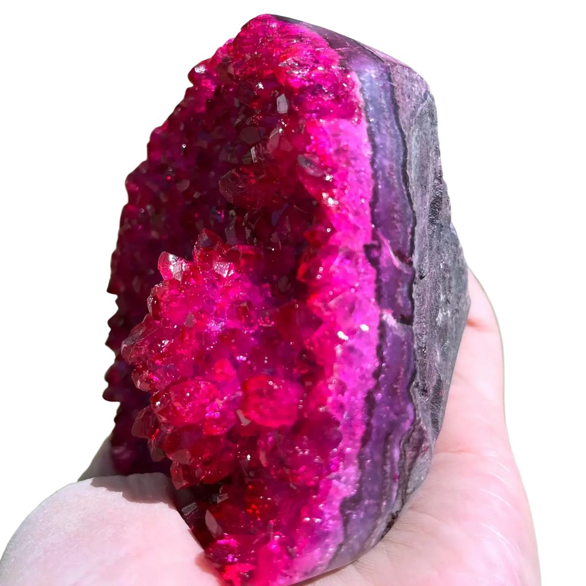 A vibrant pink quartz geode crystal cluster with sparkling purple formations for home decor