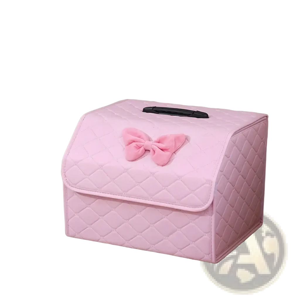 Pink quilted car trunk organizer made of soft fabric with a plush bow on top for stylish storage and organization