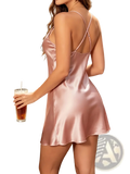 A soft pink satin crossback slip dress with delicate crisscross straps and a flared hem for elegant wear