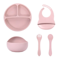Pink silicone baby feeding set with suction base includes three-compartment plate bowl bib and utensils for mealtime