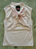 A pale pink sleeveless blouse with fine vertical stripes and a matching bow at the collar by retro vixens