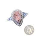 A pink teardrop zircon engagement ring with a pear-shaped pink diamond haloed by sparkling clear diamonds