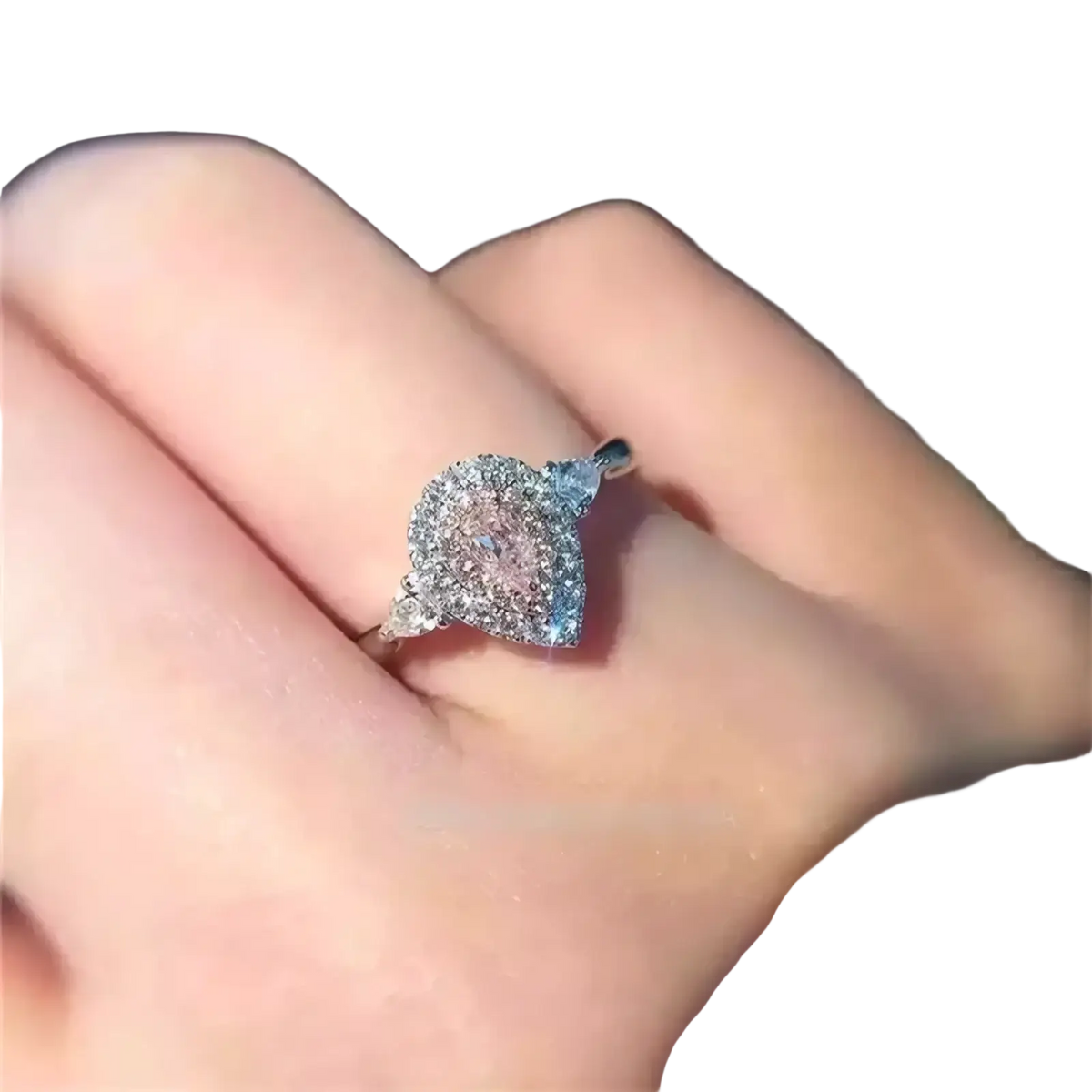 A pink teardrop zircon engagement ring with a sparkling centerpiece set in a sleek silver pavé band
