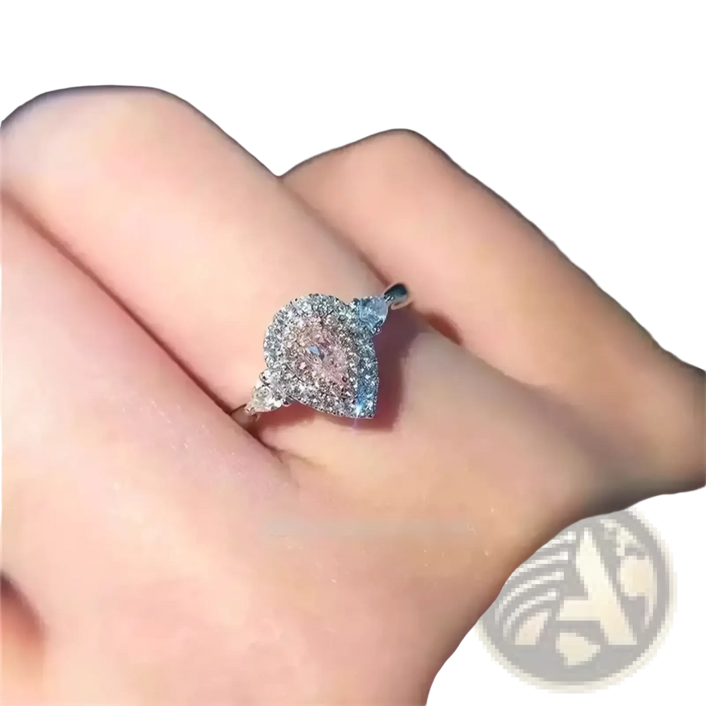 A pink teardrop zircon engagement ring with a sparkling centerpiece set in a sleek silver pavé band