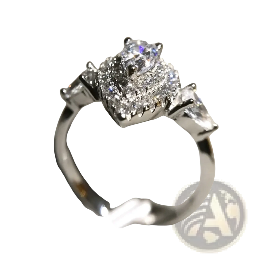A pink teardrop zircon engagement ring with a sparkling silver band and pear-shaped diamond surrounded by round and baguette diamonds