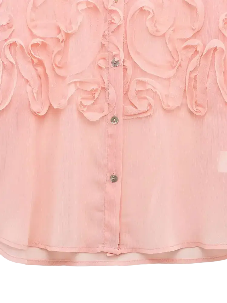 A delicate pink textured ruffled button up blouse with intricate front ruffles and silver toned buttons