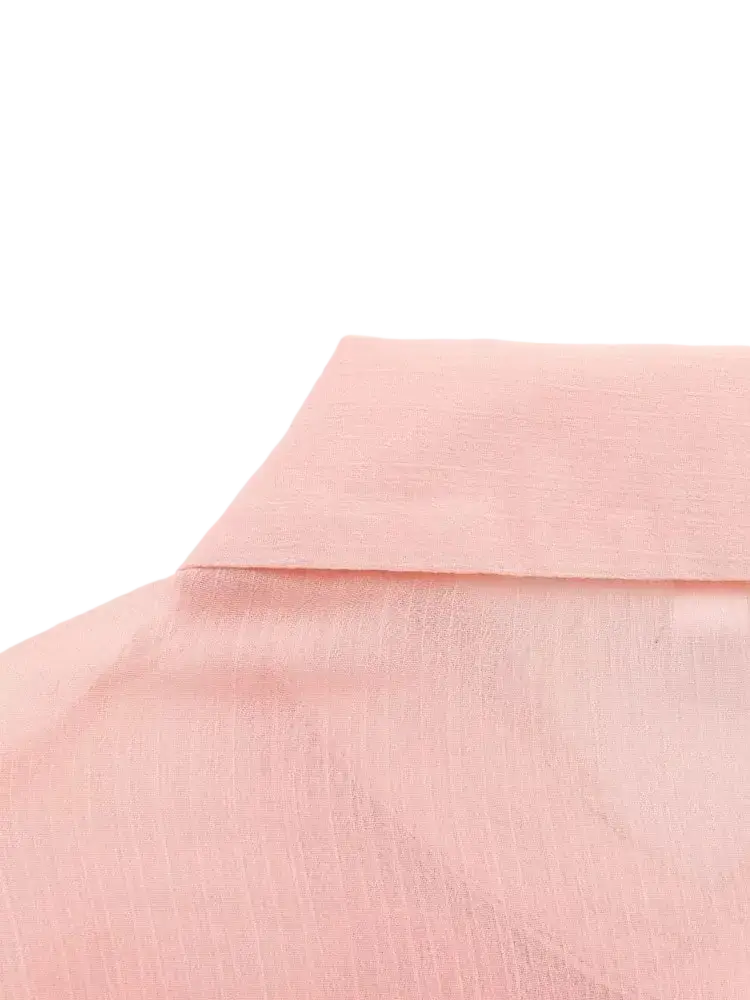 Pink textured ruffled button up blouse made of soft pink subtly textured fabric with a clean fold at the collar
