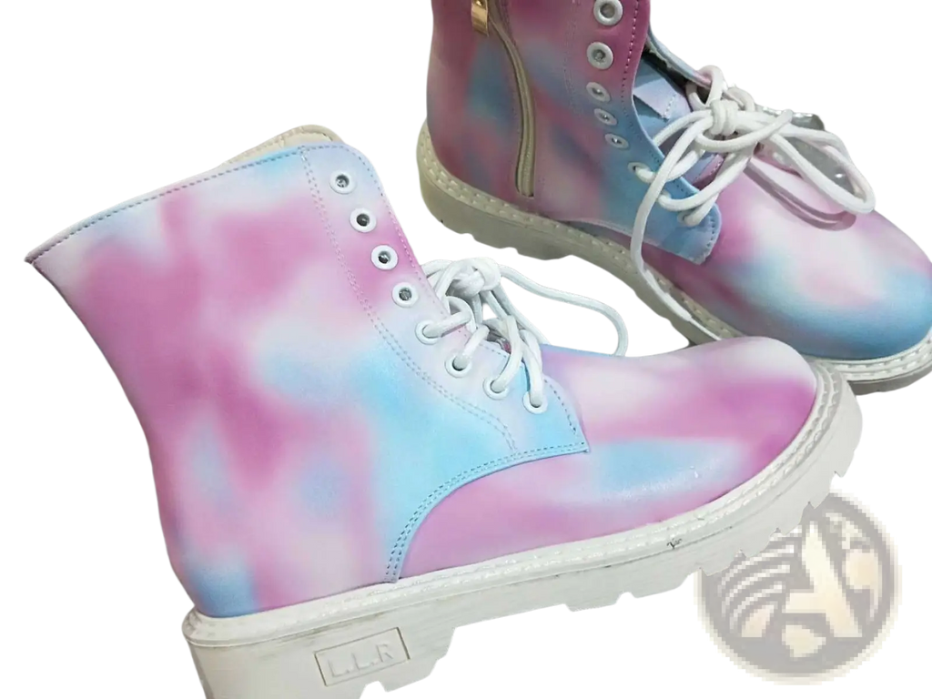 Pink tie dye combat boots with chunky white sole white laces close up view of front side