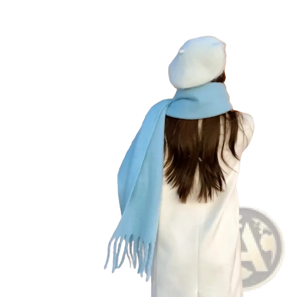 Pink winter cashmere scarf for women shown as a soft light blue woolen scarf with fringed ends draped around the neck