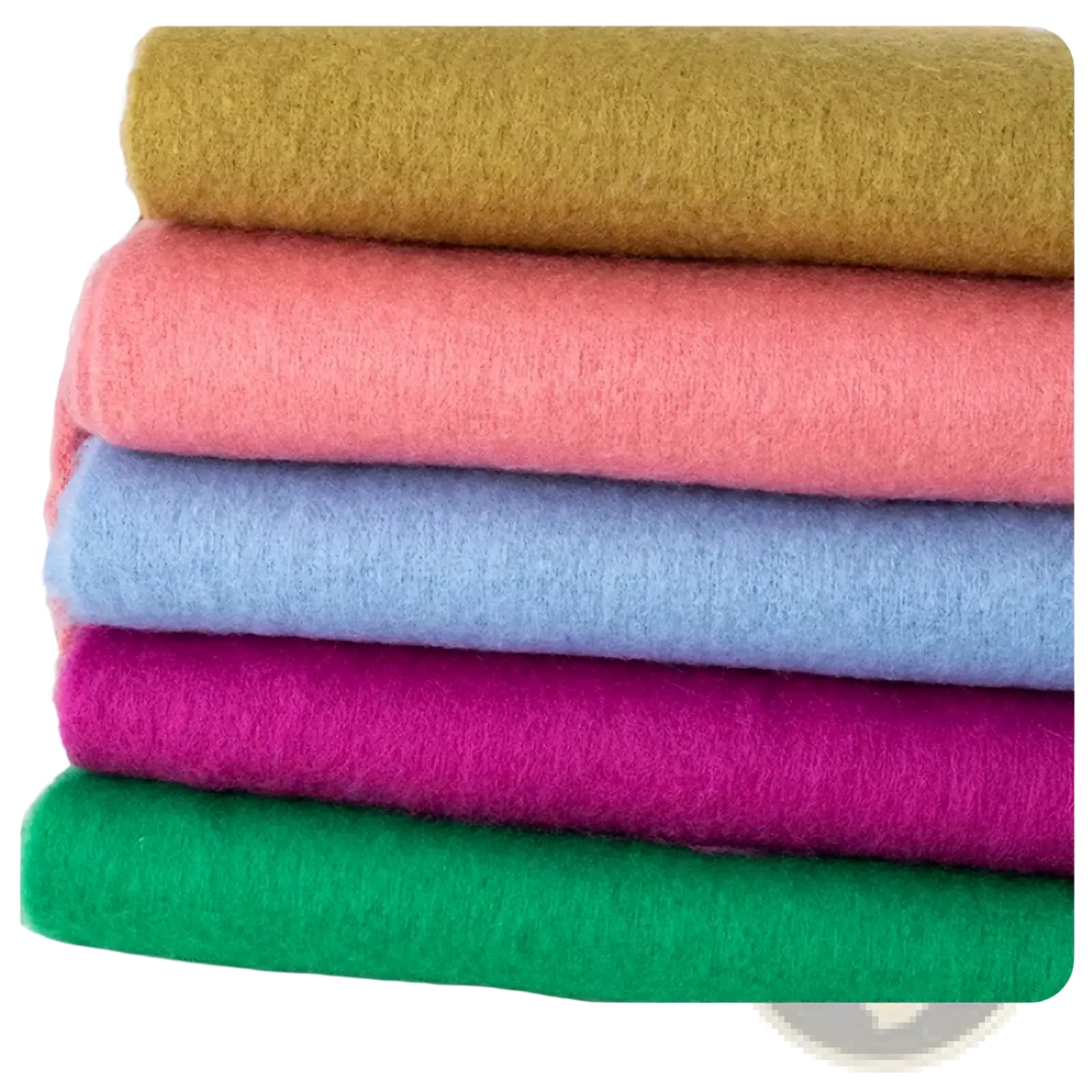 Stack of colorful felt sheets in soft pastel and vibrant hues complementing a pink winter cashmere scarf for women