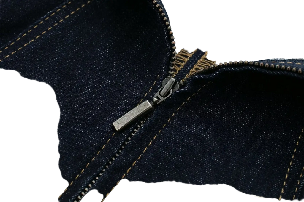 Dark blue denim jacket zipper with metallic pull tab and tan stitching on pinstripe denim strapless midi dress back