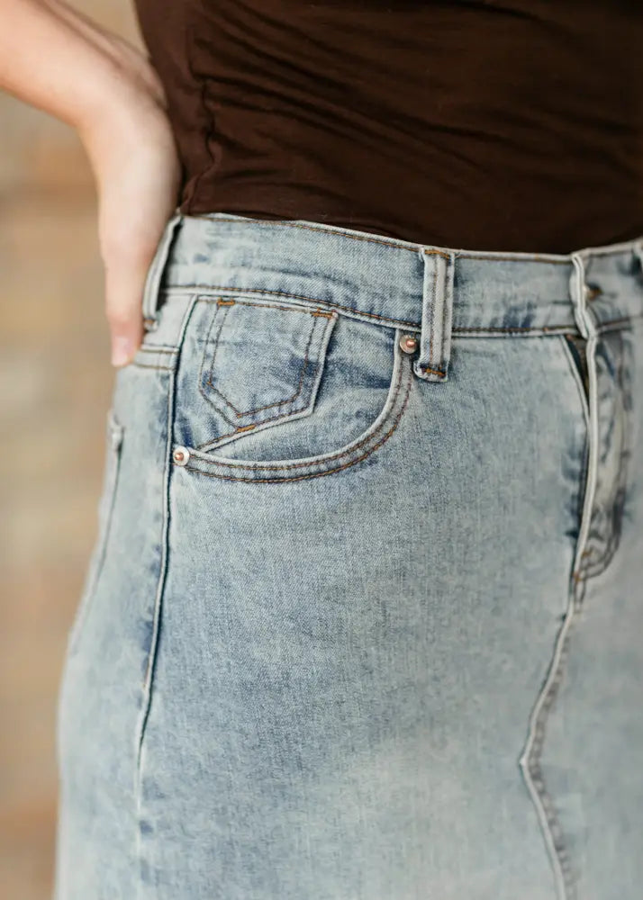 Back view of piper light wash a-line denim maxi skirt with classic back pocket design and subtle fading