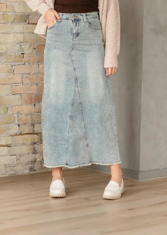 Piper light wash a-line denim maxi skirt with frayed hem and classic front pockets in light-wash denim