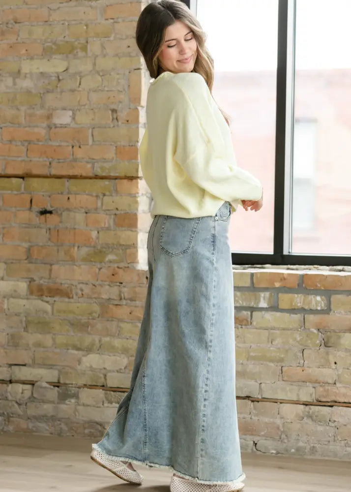 Piper light wash a-line denim maxi skirt with classic five-pocket design and frayed hem in light blue denim